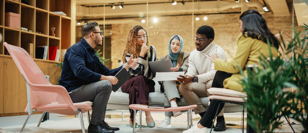 A group of professionals gather review documents relates to change management roles and responsibilities matrix